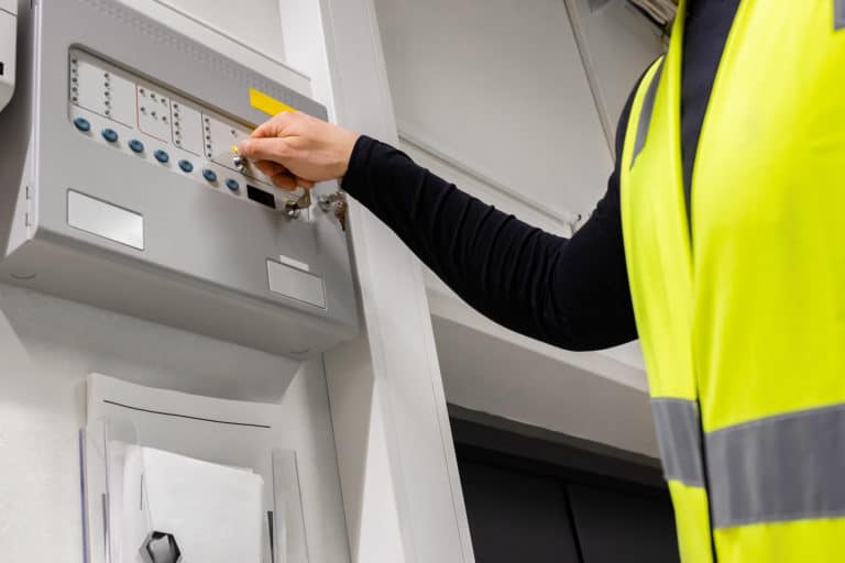 Fire and Life Safety Director operating a fire alarm system