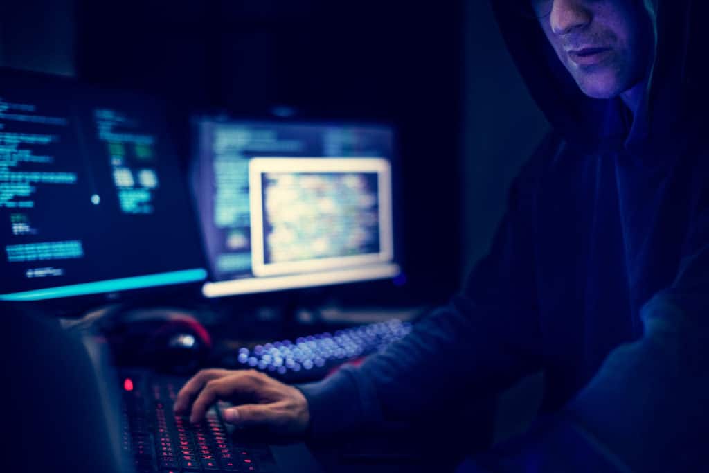 Hacker trying to steal information sitting at his computer