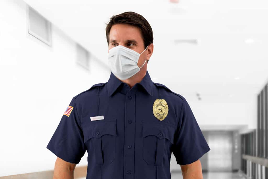 NYC security guard wearing a surgical mask standing in a hallway